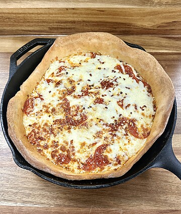 Mouthwatering deep-dish pizza with pepperoni, baked to perfection in a cast-iron skillet.