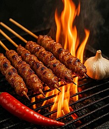 Delicious satay skewers sizzling on the grill with garlic and chili for flavor.