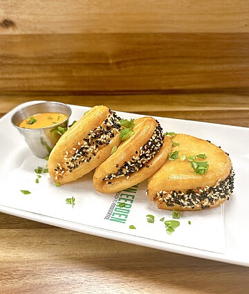 Crispy sesame bites served with a creamy dipping sauce for a delightful snack experience.