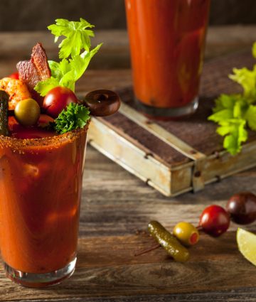 Spicy Bacon Vodka Bloody Mary topped with fresh garnishes and vibrant flavors. Perfect for brunch!