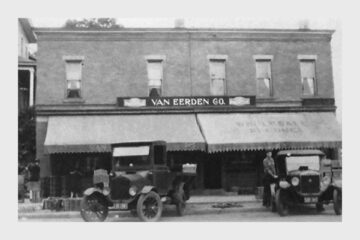 Historic Van Eerden Co. storefront with classic cars showcasing early 20th-century commerce.